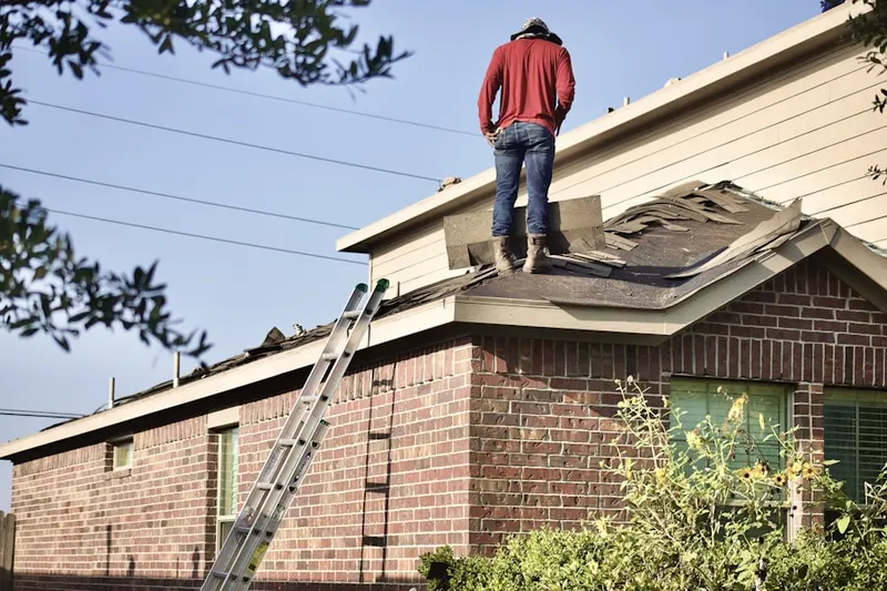 Professional roofer working on a residential roof in New Dover